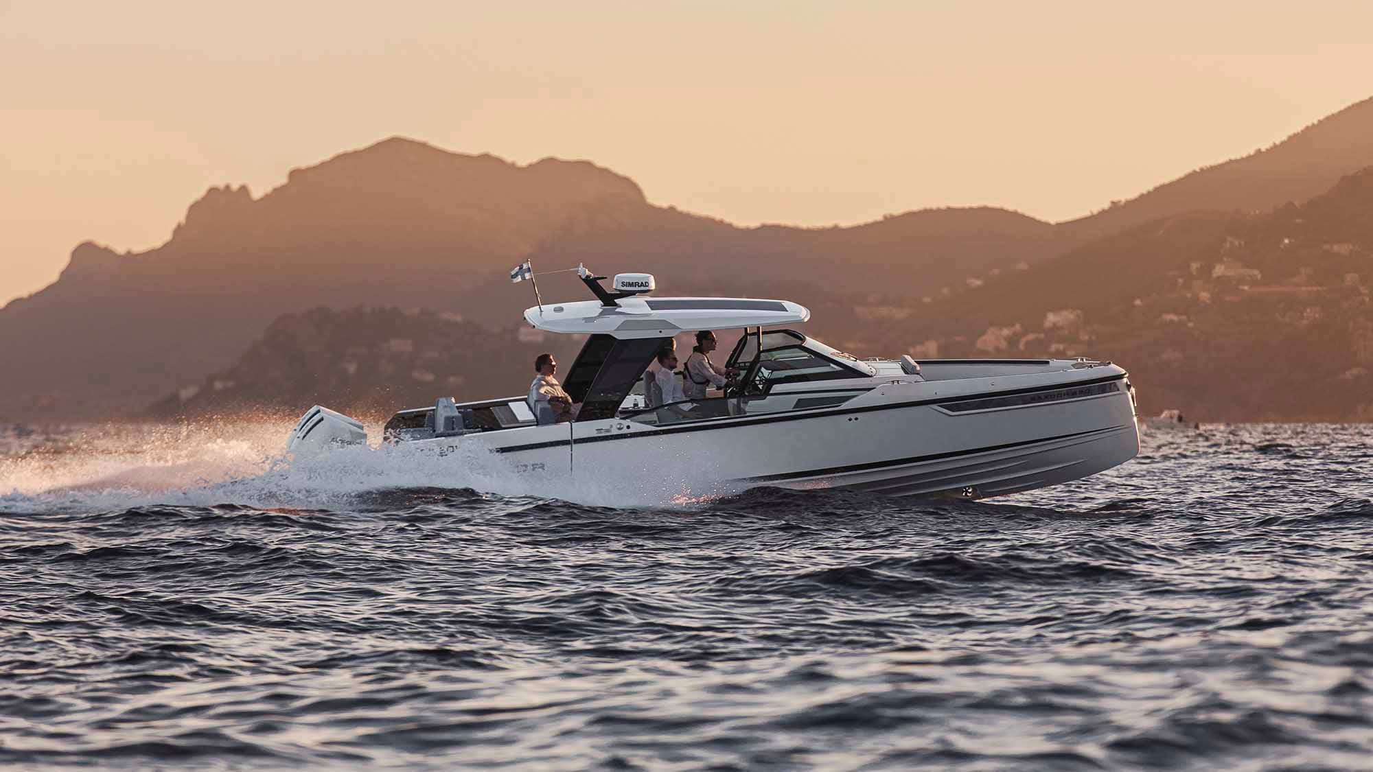 Saxdor 320 GTO under way at golden hour, three guests aboard under the hardtop